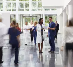 Hospital staff walking through a medical facility, intentionally blurred to look artistic