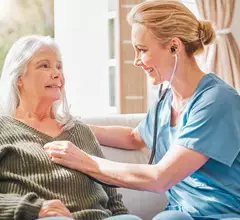 older patient with a doctor at their house