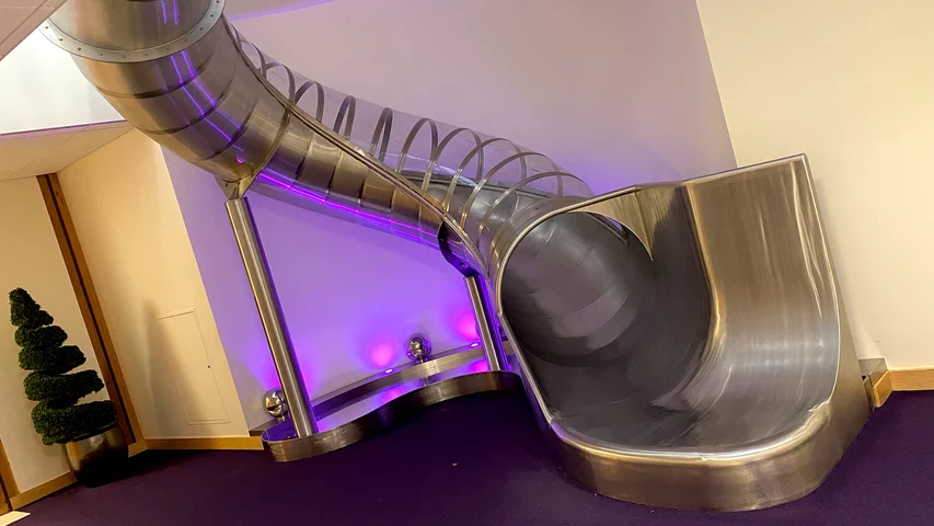 One of two slides at Epic to move between levels of the buildings, this one is in the Heaven office building. Epic HQ art work. Photo by Dave Fornell