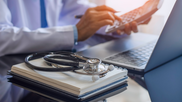 doctor comparing the costs of different medical treatments