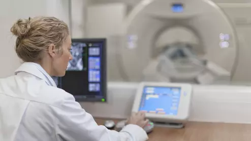 a doctor at a medical device control panel