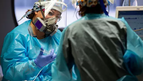 Nurses caring for a COVID-19 patient in the COVID unit at Banner University Medical Center in Phoenix.