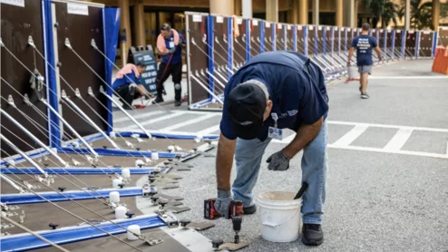 Members of the Tampa General Hospital facilities team install AquaFence panels around the lower areas of the hospital campus to protect it from expected flooding due to predicted heavy rain and storm surge water from Hurricane Helene. Photo from Tampa General Hospital.