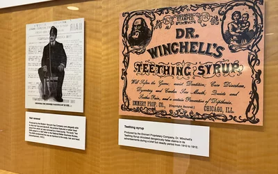 Left, an early 20th century advertisement for a hair growth device that the AMA fought to remove from the market because because it did not work and it caused damage to the patient's scalp, hair and head. Right, a teething syrup marketed for children that included dangerous, even deadly, false claims between 1910-1912.Part of quackery, snake oil, medical frauds display at the AMA headquarters.