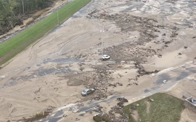 Employee cars that were carried away in the swift flood currents and debris around the Baxter North Cove facility. Photo by Aerial Lens.