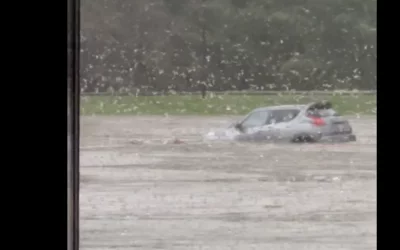 Baxter employee's car being washed away downtreat with the flood current at the Baxter North Cove facility. 