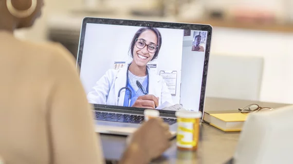 A patient has a telehealth visit with their doctor remotely in their home via video conferencing. The COVID-19 cause massive movement to telehealth since 2020.